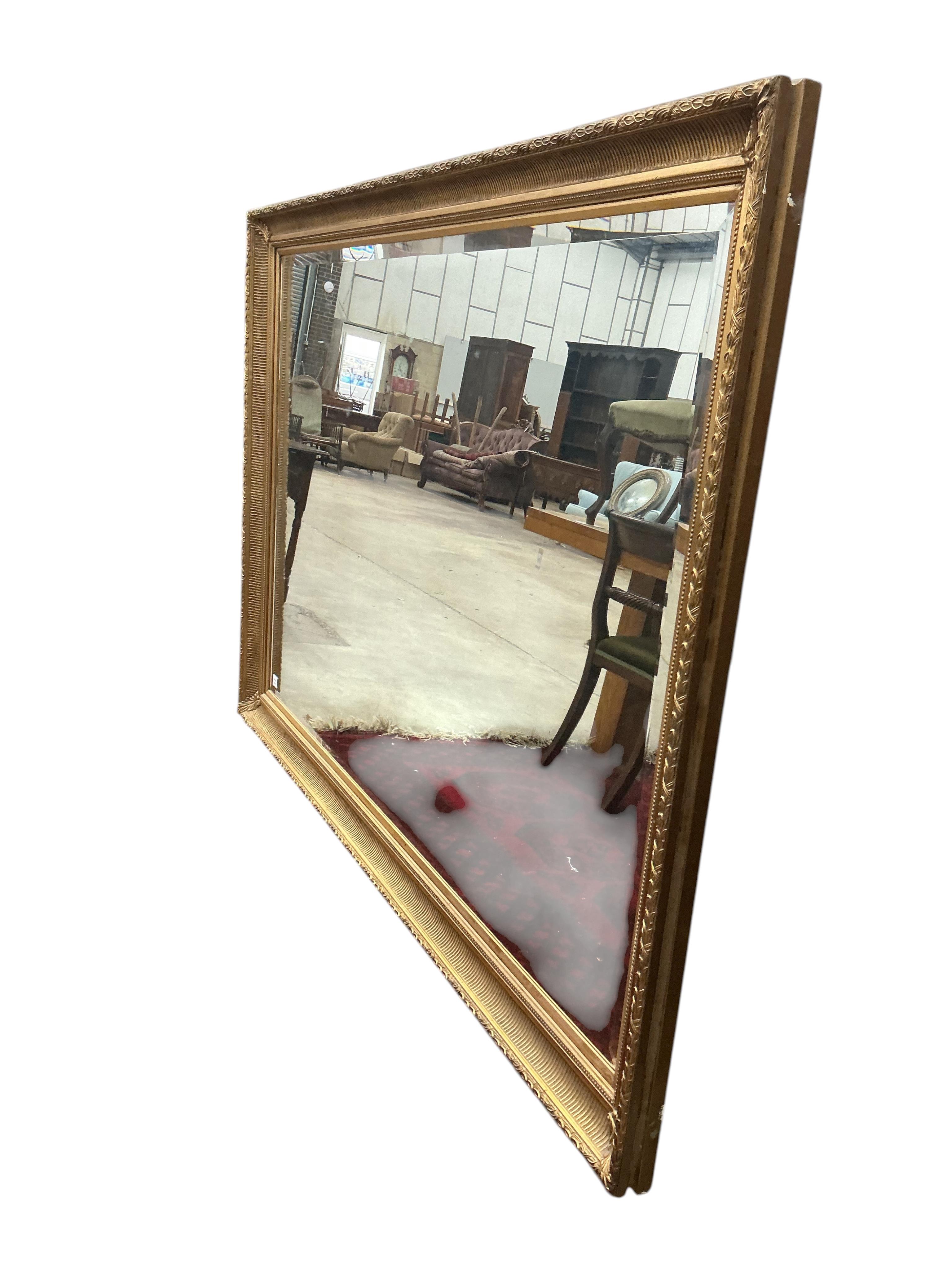 A large Victorian style rectangular gilt composition wall mirror, width 204cm, height 142cm